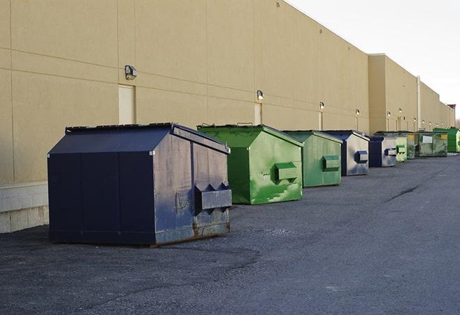 a row of construction dumpsters parked on a jobsite in Arlington, MA